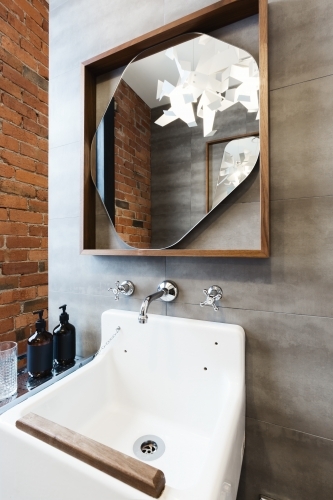 Close up of vintage style bathroom vanity in renovated warehouse apartment - Australian Stock Image