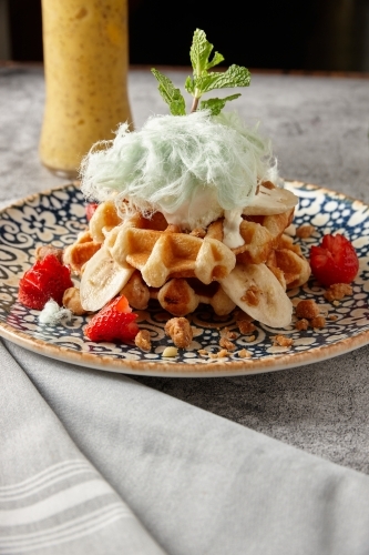 Close up of waffles, ice cream and fairy floss dessert - Australian Stock Image