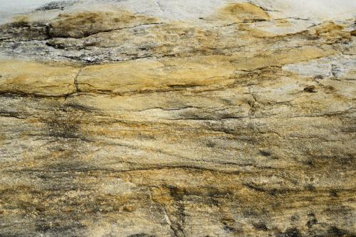 Close up of yellow horizontal striped rock with cracks - Australian Stock Image