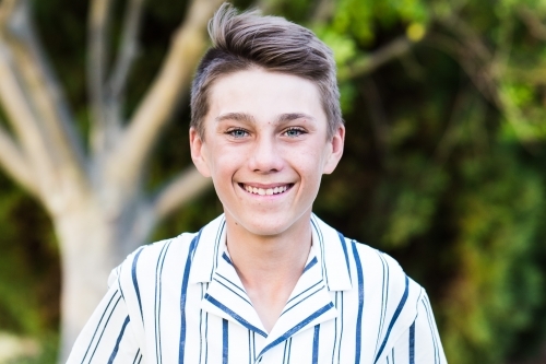 Close up of young teenage boy smiling - Australian Stock Image