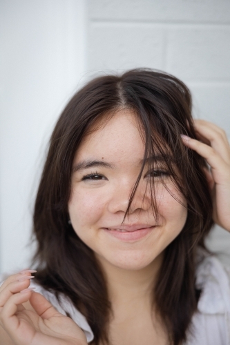 Close-up portrait of teenage girl smiling - Australian Stock Image