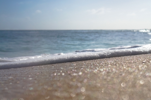 Close up sand and foam - Australian Stock Image