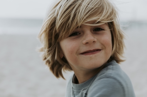 Close up shot of a boy smiling - Australian Stock Image