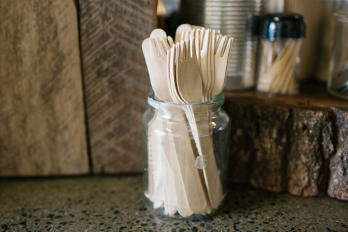 close up shot of a jar full of disposable cutleries - Australian Stock Image