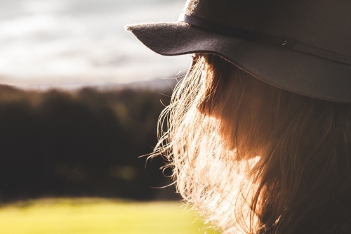 Close-up shot of a woman with countryside in the background - Australian Stock Image