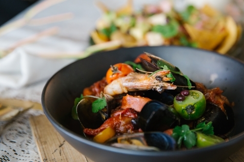 Close up shot of shrimp dish in a black bowl - Australian Stock Image