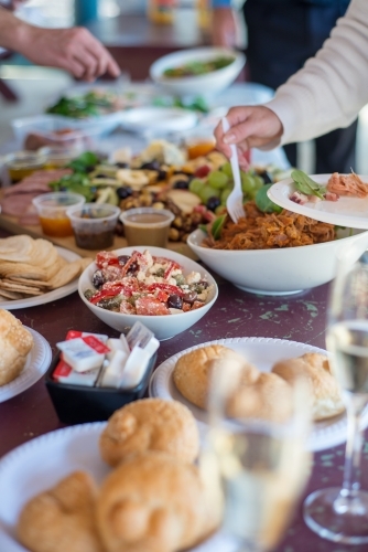 Close up shot of table filled with bread and food - Australian Stock Image