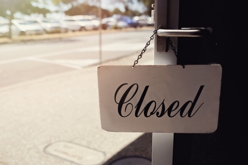 Closed sign hanging at shop door - Australian Stock Image