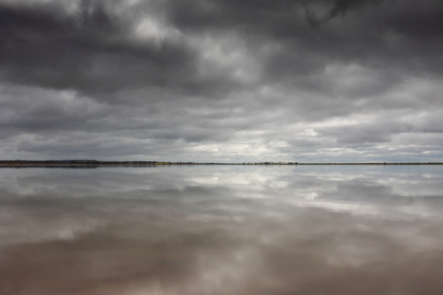 Cloud reflections over lake - Australian Stock Image