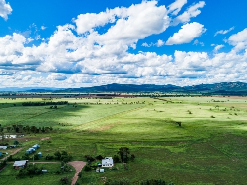 Clouds making sunlight and shadow patterns over farmland - Australian Stock Image