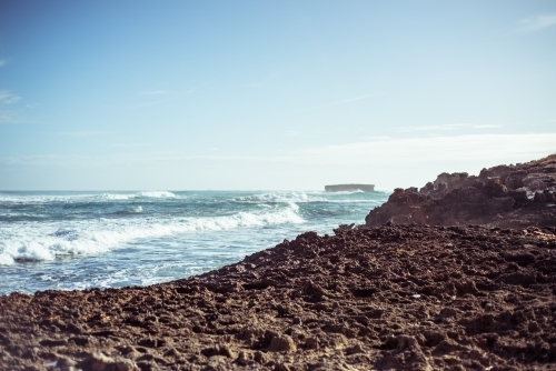 Coastline looking out over rocks to crashing waves - Australian Stock Image