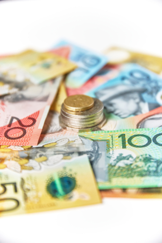 Collection of Australian banknotes and coins scattered on a flat surface - Australian Stock Image