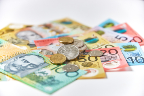 Collection of Australian banknotes and coins scattered on a flat surface - Australian Stock Image