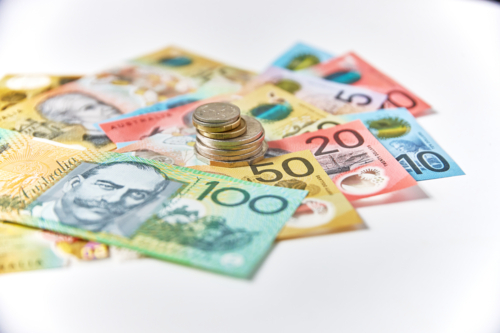 Collection of Australian banknotes and coins scattered on a flat surface - Australian Stock Image