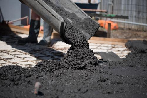 Coloured concrete pouring out of cement truck chute - Australian Stock Image