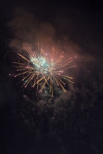 Colourful fireworks display in sky at night - Australian Stock Image