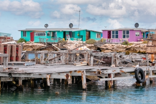 Colourful fishing shacks and jetty at the Abrolhos Islands - Australian Stock Image