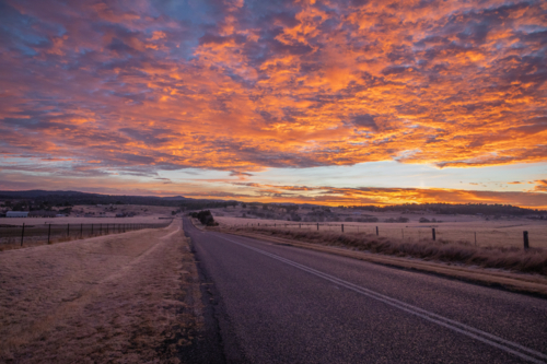 Colourful sunrise skies over a country road - Australian Stock Image