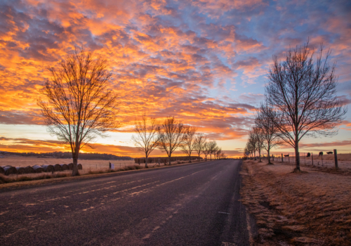 Colourful sunrise skies over a country road - Australian Stock Image