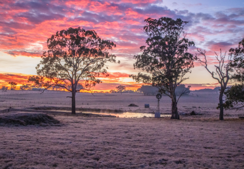 Colourful sunrise skies over a country scene - Australian Stock Image