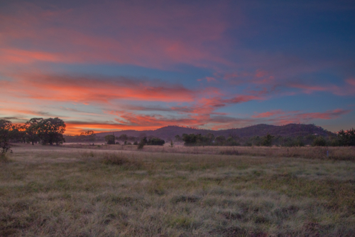 Colourful sunrise skies over a country scene - Australian Stock Image