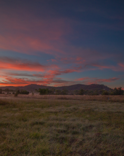 Colourful sunrise skies over a country scene - Australian Stock Image