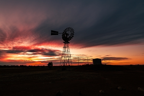 Colourful Sunset with windmill silhouette. - Australian Stock Image