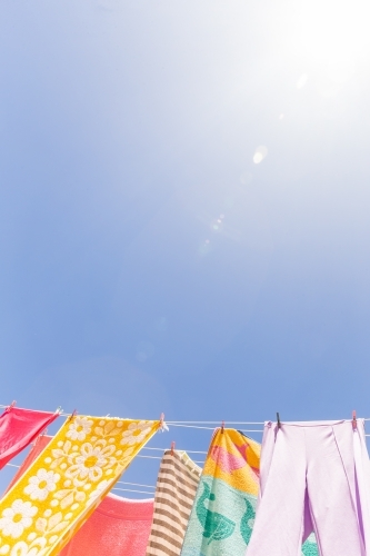 Colourful towels and swimmers hanging on washing line - Australian Stock Image