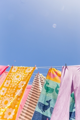 Colourful towels and swimmers hanging on washing line - Australian Stock Image