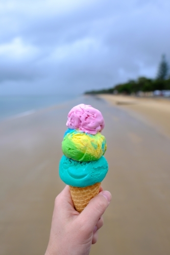 Colourful triple scoop ice cream on the beach at Hervey Bay - Australian Stock Image