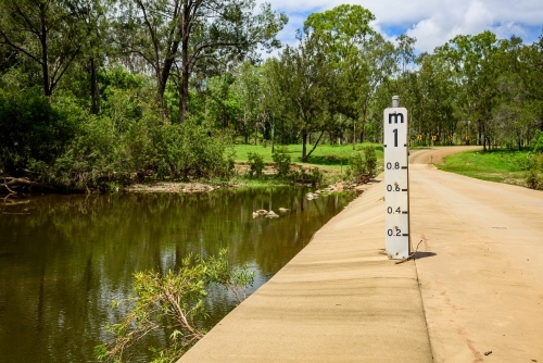 Concrete flood way with water level gauge in Queensland, Australia - Australian Stock Image