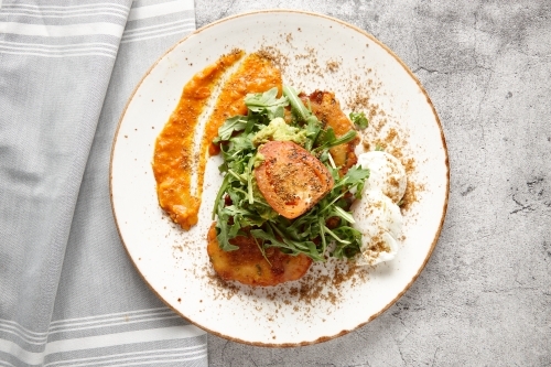 Corn fritters and eggs breakfast dish - Australian Stock Image