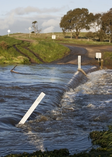 Country road through flooded causeway - Australian Stock Image