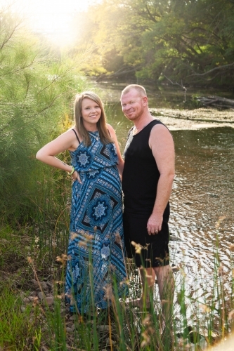 Couple standing together at riverside - Australian Stock Image