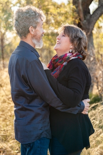 Couple standing together looking at each other - Australian Stock Image