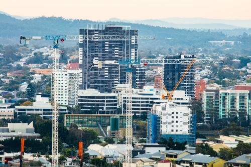 Cranes over West End with residential and office buildings of Milton in the background - Australian Stock Image