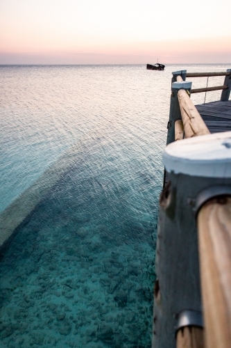 crystal clear water and jetty on heron island at sunset