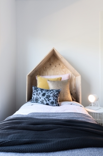 Cute wooden tent style wooden bedhead in a styled children's bedroom