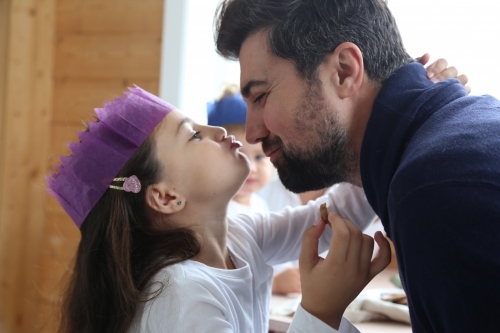 Dad and daughter showing affection wearing Christmas hat - Australian Stock Image