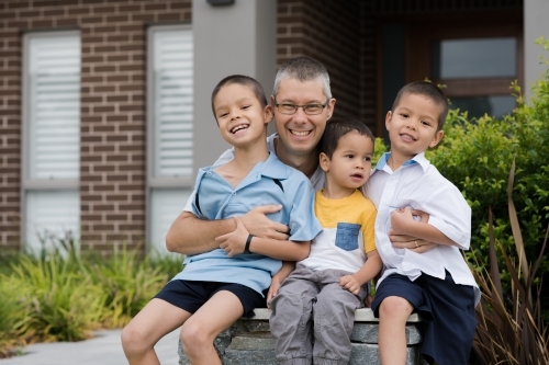 Dad sending his boys off to school on their first day of school - Australian Stock Image