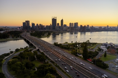 Dawn aerial view of the Perth City skyline and Narrows Bridge on a hazy morning.