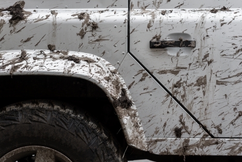 Detail of a four wheel drive vehicle splattered with mud