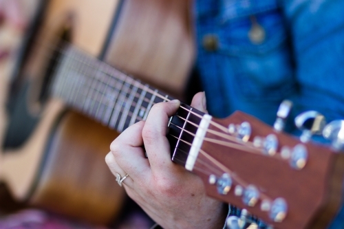 Detail of fingers on guitar strings