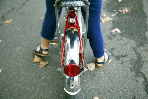 Detail of young girl riding bike from behind - Australian Stock Image