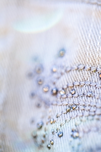 Diamante sparkles and threads making pattern on clothing - Australian Stock Image