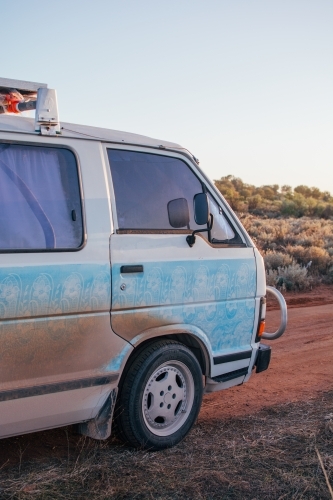 Dirty camper van parked at roadside camp - Australian Stock Image