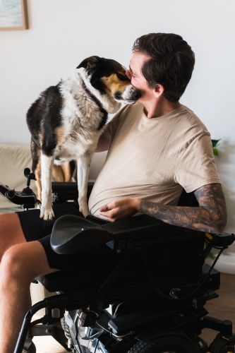 disabled man with his dog at home