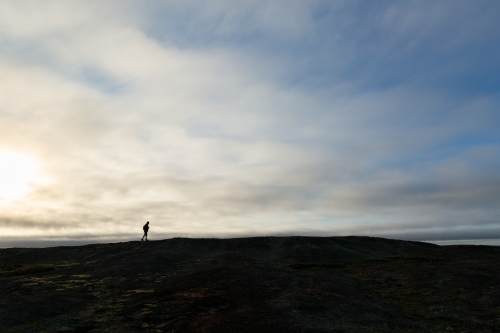 Distant figure silhouetted on horizon - Australian Stock Image