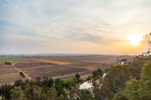 Distant paddock landscape with smokey sky - Australian Stock Image