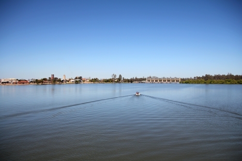 Distant view of boat on lake mulwala - Australian Stock Image